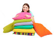 Foto: Beautiful young girl with pillows isolated on white. Beautiful young girl with pillows isolated on white.