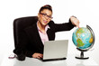 Smiling manageress pointing to a globe