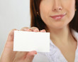 Businesswoman showing and handing a blank business card.