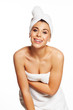 Sexy woman getting out of her bath wearing towels