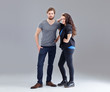 Young couple on grey background