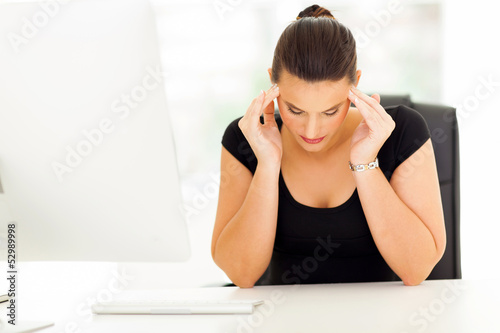 Photo: businesswoman having headache in office businesswoman having headache in office