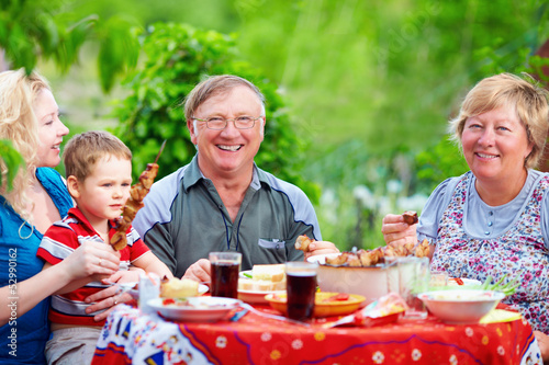 Photo: happy family together on picnic, summer outdoors happy family together on picnic, summer outdoors