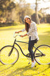 young woman riding a bicycle outdoors