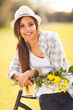 young woman with flowers posing next to a bike