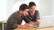 Chinese woman excitedly shopping online with boyfriend