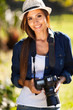 pretty woman with a camera outdoors