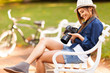 pretty female student photographer checking photos on her camera