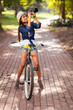 attractive young woman taking pictures on her bike