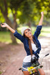 carefree young woman arms open outdoors