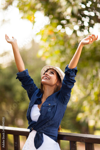 Photo: young woman outdoors with arms outstretched young woman outdoors with arms outstretched
