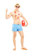 Full length portrait of a male in swimming shorts, holding a bea