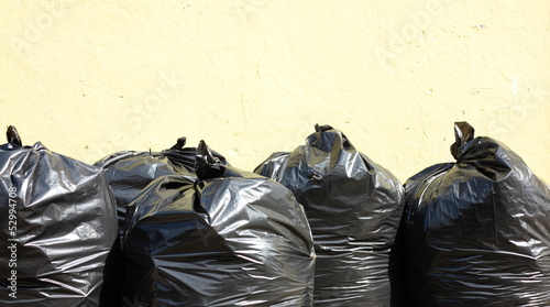Photo: Pile of full black garbage bags Pile of full black garbage bags