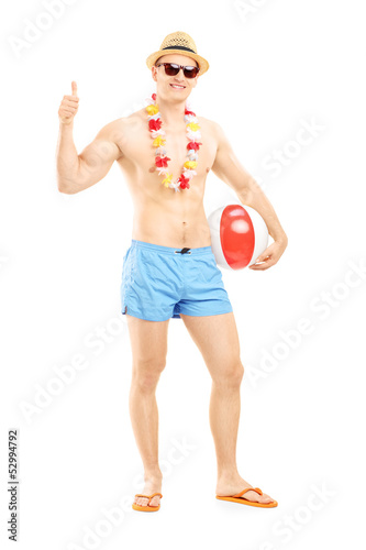 Photo: Full length portrait of a male in swimming shorts, holding a bea Full length portrait of a male in swimming shorts, holding a bea