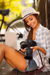 young photographer checking photos on her camera