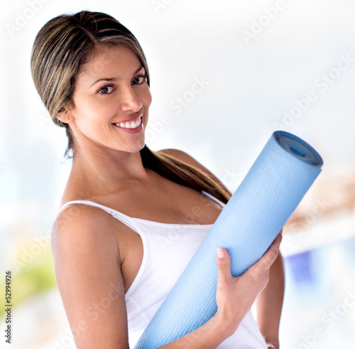 Photo: Woman with a yoga mat Woman with a yoga mat