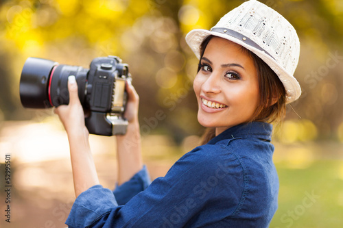 Photo: young woman learning to use camera young woman learning to use camera