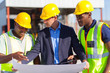 architect and construction workers on construction site