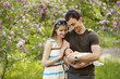 Photo: Young couple with newborn son outdoors in spring Young couple with newborn son outdoors in spring