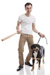 Photo: Young Caucasian man holding bat, with Entlebucher Sennenhund dog Young Caucasian man holding bat, with Entlebucher Sennenhund dog