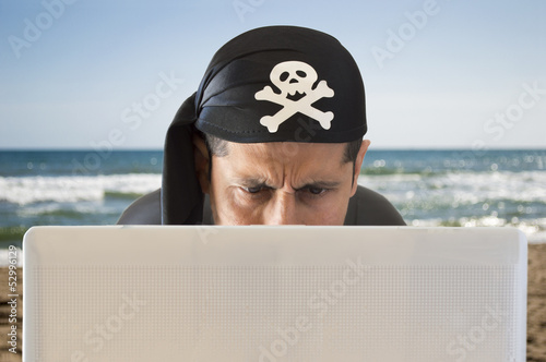Photo: hacker looking confused on the beach hacker looking confused on the beach