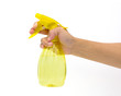 Hand holding a plastic spray bottle