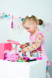 Elegant girl playing with cosmetics and jewelry