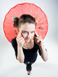 cute girl holding a chinese umbrella and stretching eyes
