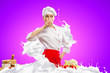Asian female cook against milk splashes