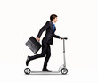 Businessman riding scooter