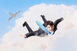 Photo: Young businessman flying with parachute on back Young businessman flying with parachute on back