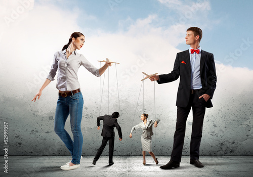 Photo: Businesspeople with marionettes Businesspeople with marionettes