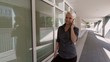 Businesswoman walking and speaking on mobile telephone