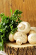 fresh mushrooms (champignons) on a wooden table