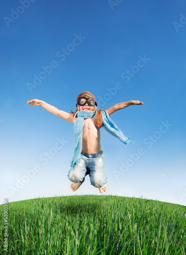 Photo: Happy kid jumping outdoors Happy kid jumping outdoors