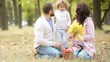 Happy family playing outdoors in autumn park