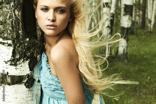 Photo: Beautiful blond woman in forest. flying hair Beautiful blond woman in forest. flying hair