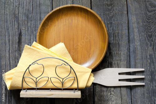 Photo: Empty plate on vintage boards with cutlery sign of food concept Empty plate on vintage boards with cutlery sign of food concept