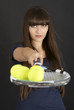Female tennis player with racket and ball on black background