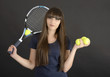 Female tennis player with racket and ball on black background