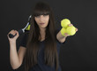Female tennis player with racket and ball on black background