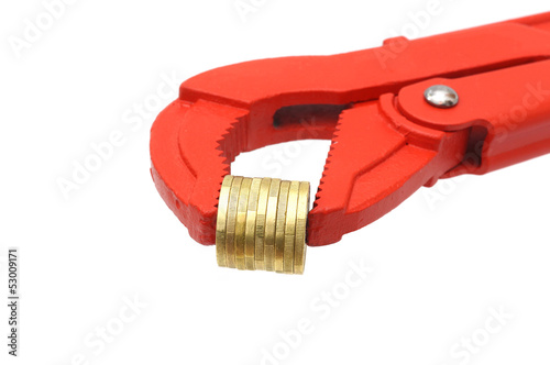 Photo: salary or income concept with pipe wrench and coins salary or income concept with pipe wrench and coins
