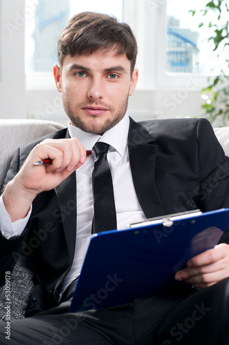 Photo: male psychologist being ready to take notes male psychologist being ready to take notes