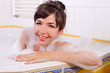 Young brunette woman in the bathtub