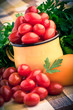 Vintage mug full of fresh cherry tomatoes