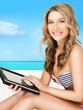 woman in bikini with tablet pc computer
