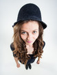 cute girl with funny peasant hat smiling in the studio