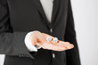 mans hand holding white casino dice