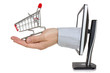 Computer monitor and hand with shopping cart