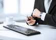 man hands with keyboard, smartphone and wristwatch